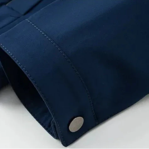 Close-up of a blue jacket collar with a button on a white background